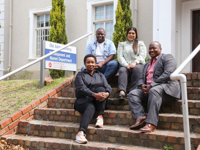 UCT Alumni Relations team sitting on the stairs